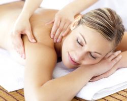 Relaxed smiling woman receiving a back massage